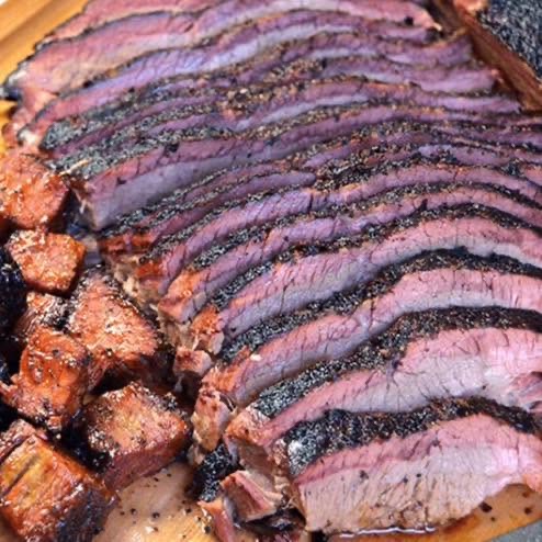 Sliced house-smoked beef brisket with a smoke ring